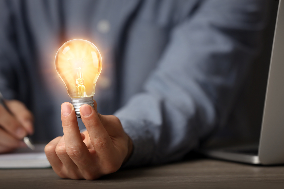 Glow up Your Ideas. Closeup View of Man Holding Light Bulb While